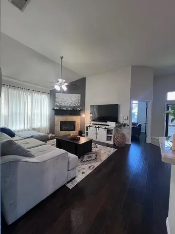 a living room with furniture wooden floor and a fireplace