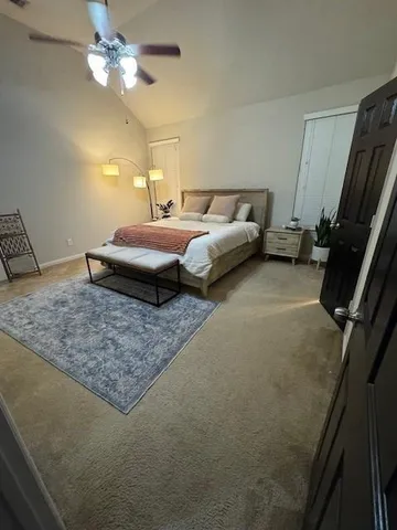 a bedroom with a bed and a chandelier