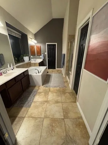 a large bathroom with a sink a large mirror and a shower