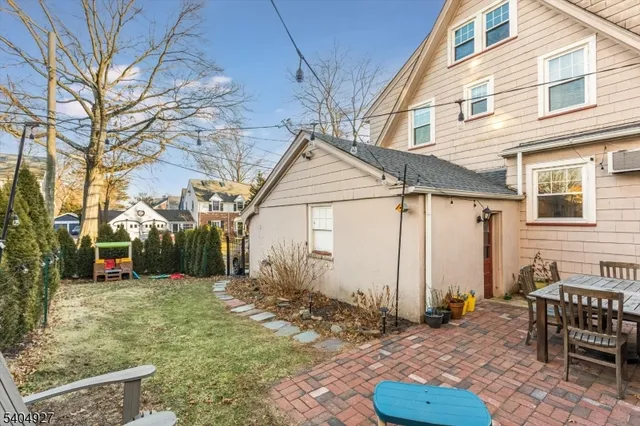 a backyard of a house with yard and outdoor seating