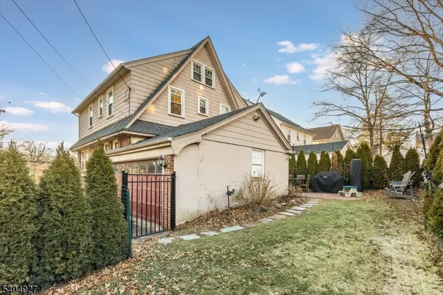 a view of a large house with a yard next to a road