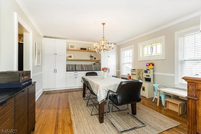 a view of a a dining room with furniture window and wooden floor