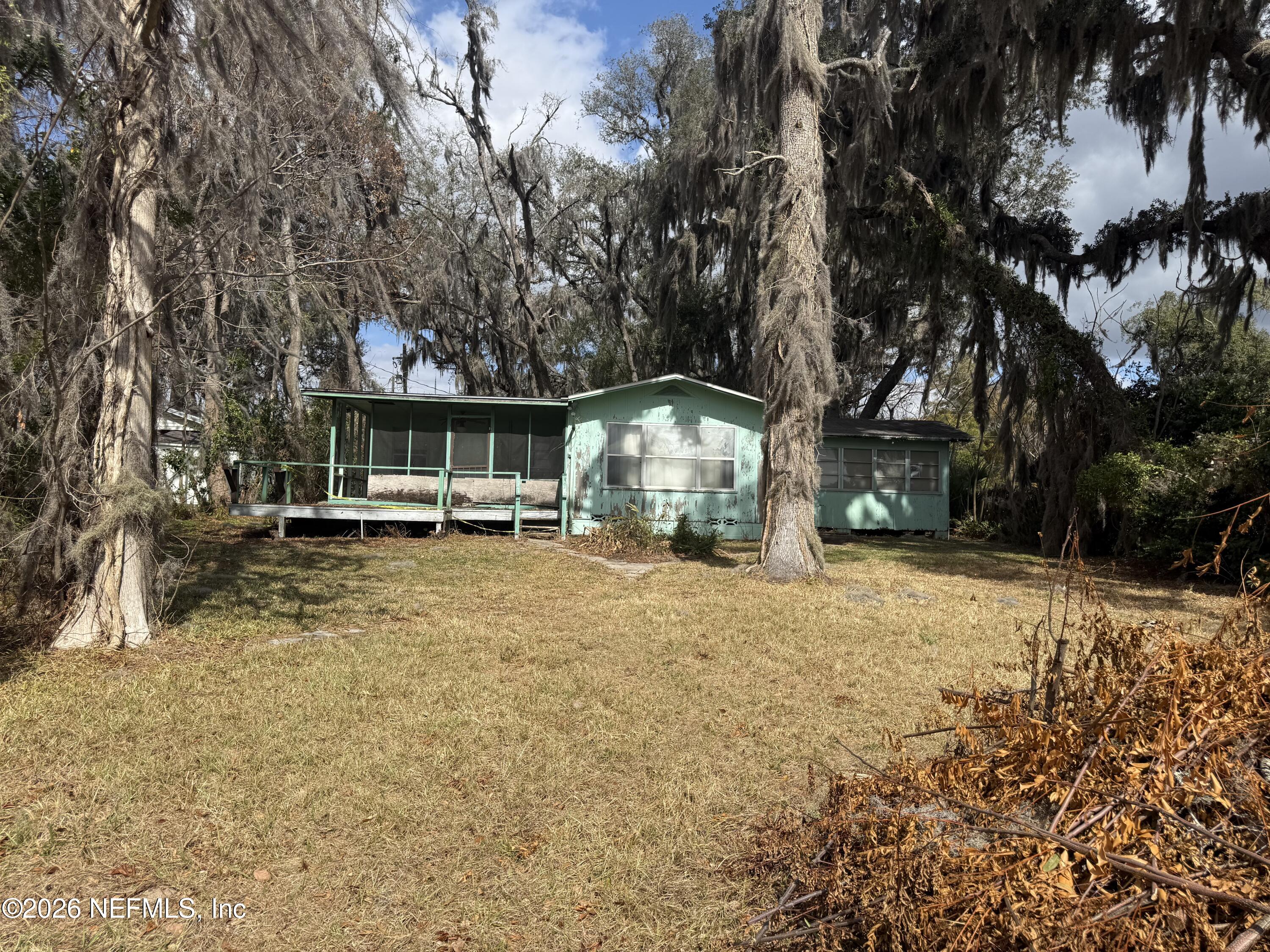 7873 State Road 21 Keystone Heights, FL 32656 - Photo 16 of 16 a front view of a house with a yard and trees