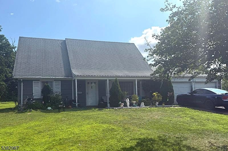 a front view of house with yard and outdoor seating
