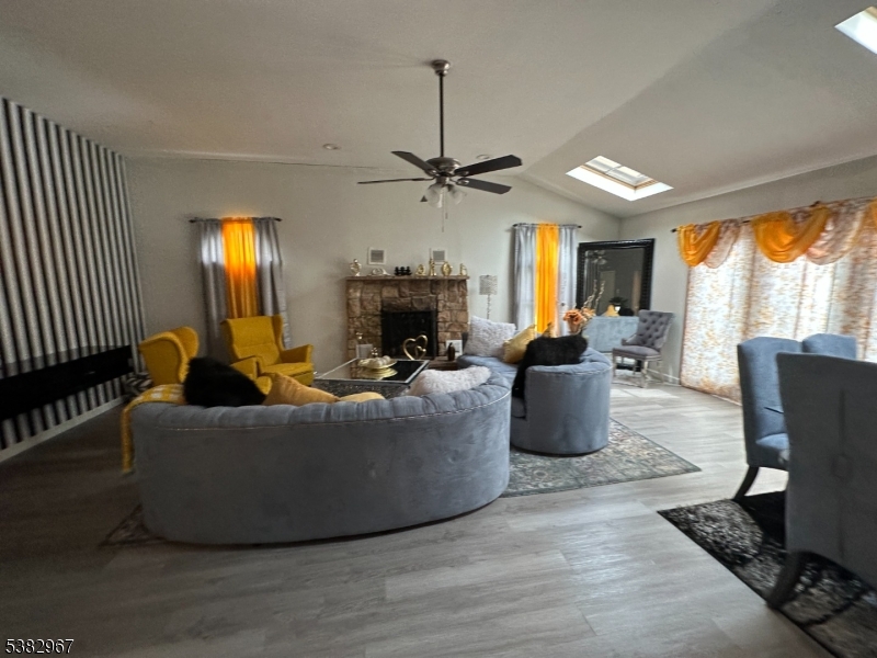 3 Webster Road Somerset, NJ 08873 - Photo 3 of 4 a living room with furniture a fireplace and a chandelier
