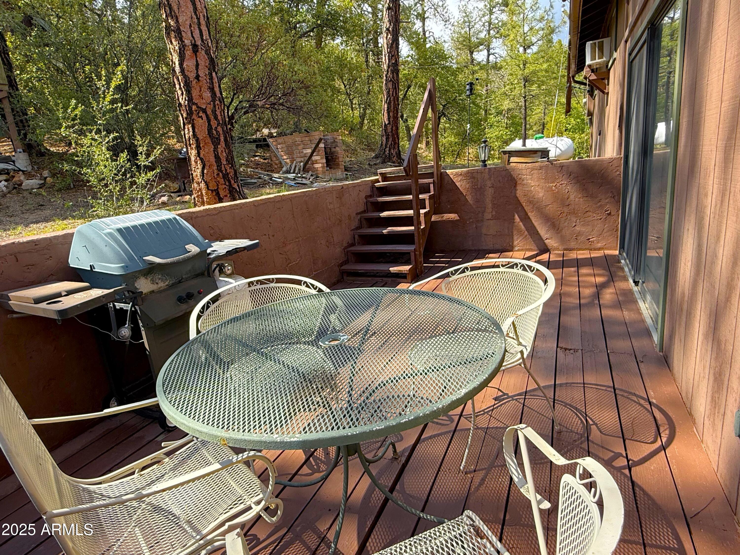 23298 South Towers Mountain Road Crown King, AZ 86343 - Photo 5 of 27 a backyard of a house with table and chairs