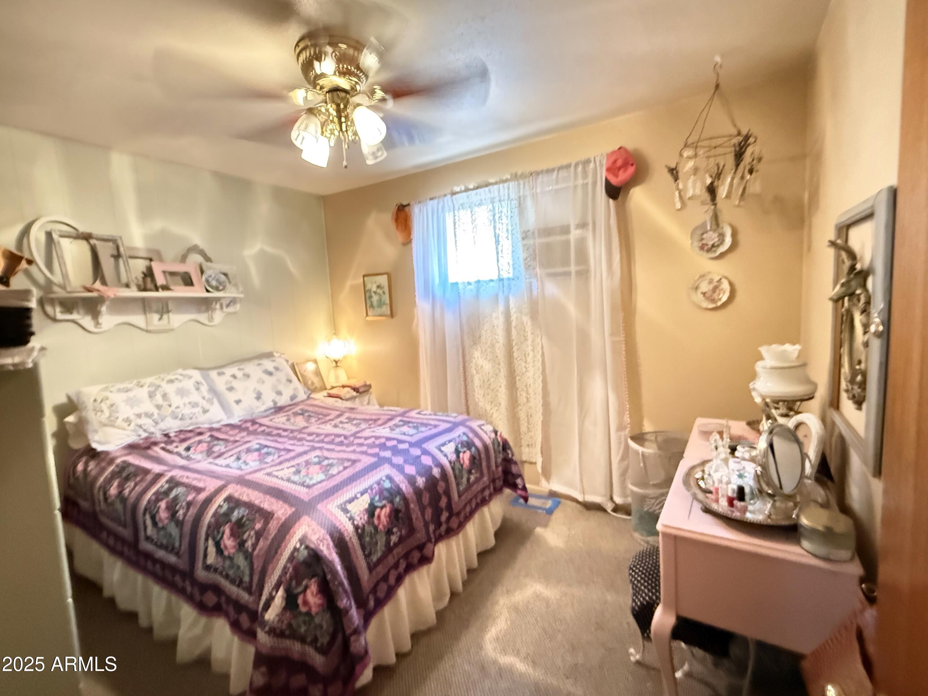 23298 South Towers Mountain Road Crown King, AZ 86343 - Photo 7 of 27 a bedroom with a bed and a chandelier