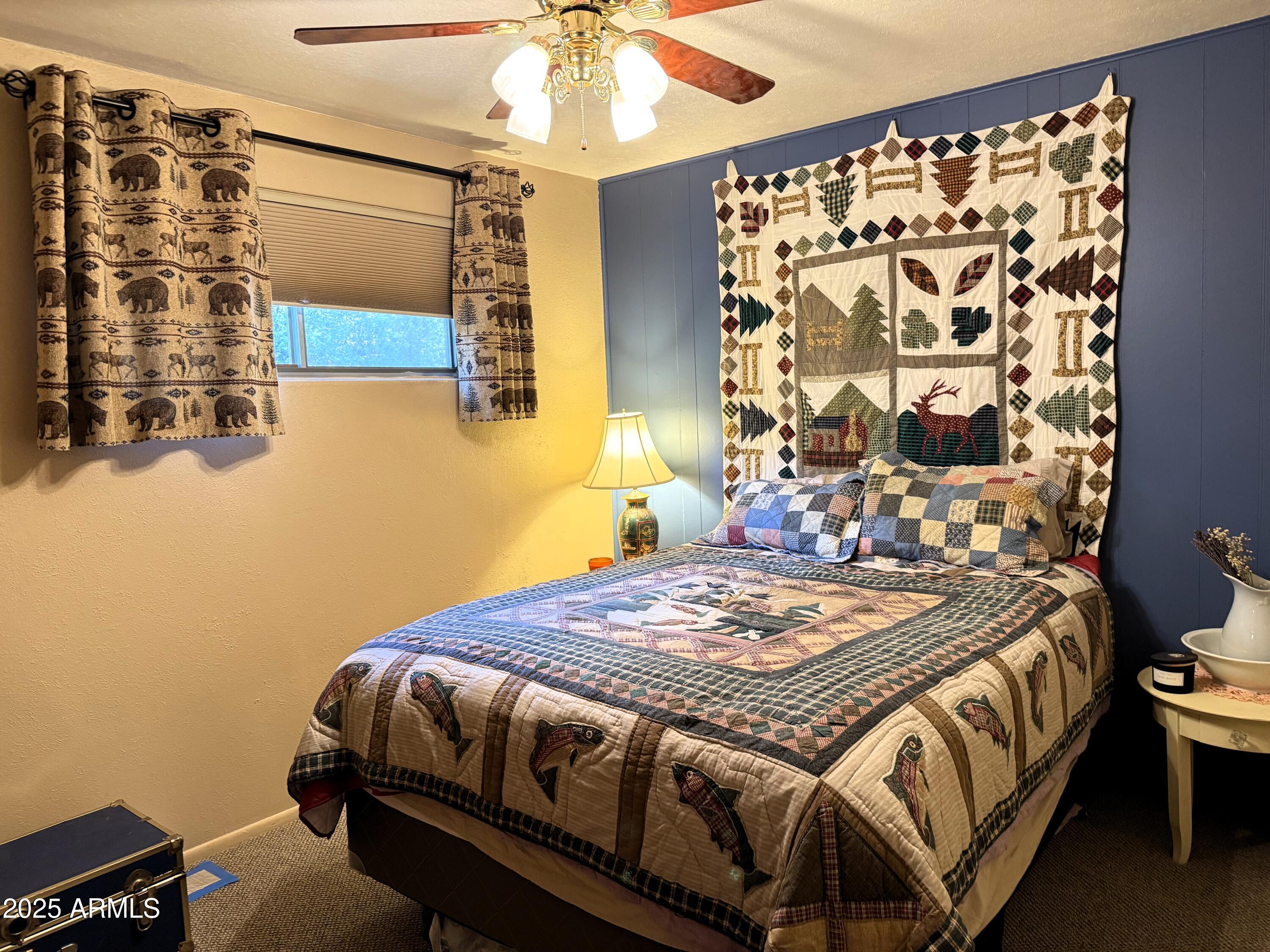 23298 South Towers Mountain Road Crown King, AZ 86343 - Photo 9 of 27 a bedroom with a bed and a chandelier