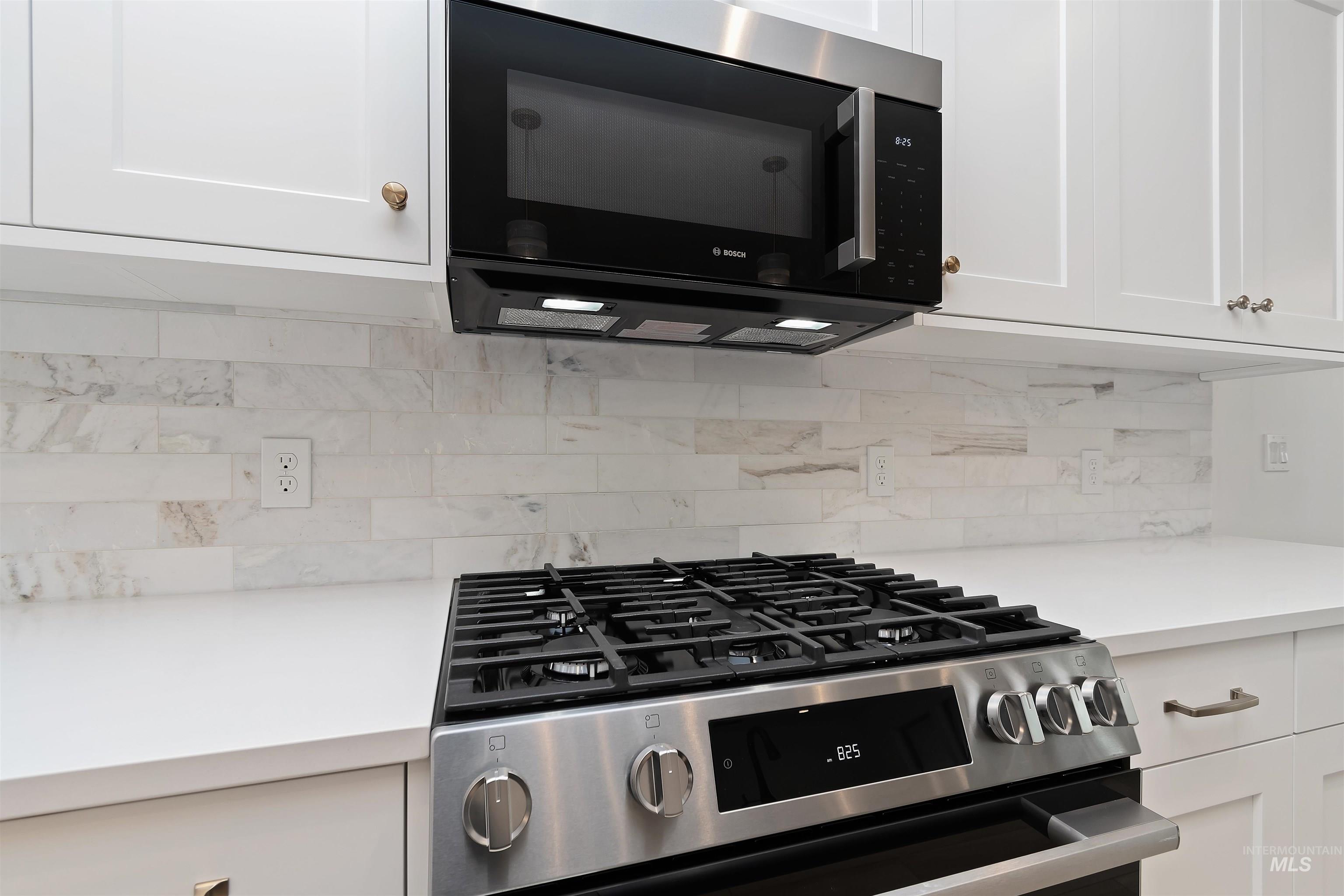 4302 Tropic Way Caldwell, ID 83607 - Photo 11 of 32 Kitchen view of stainless steel gas range oven and white cabinetry