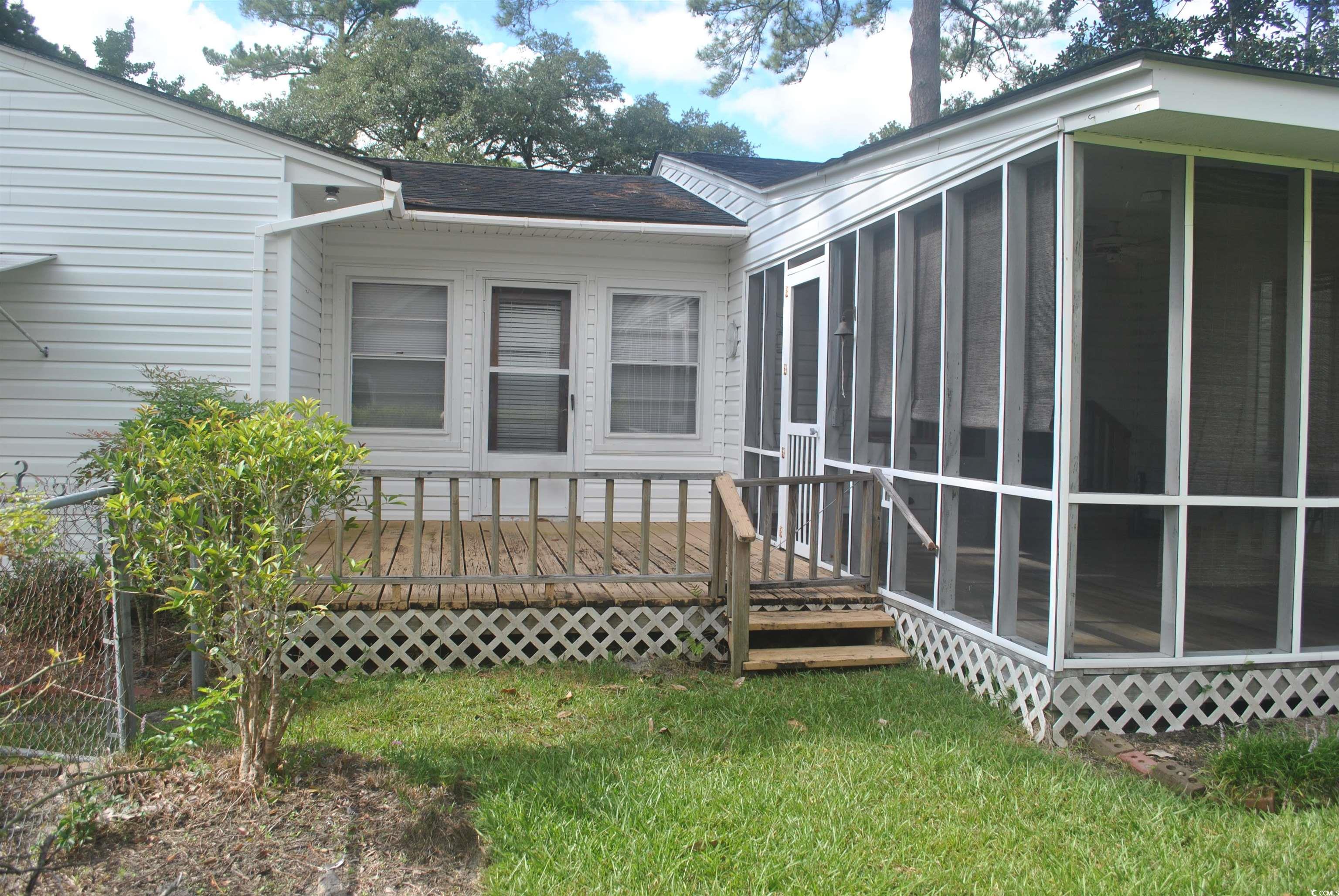 1726 Rice Street Georgetown, SC 29440 - Photo 4 of 28 Back of house with a deck, a sunroom, and a yard