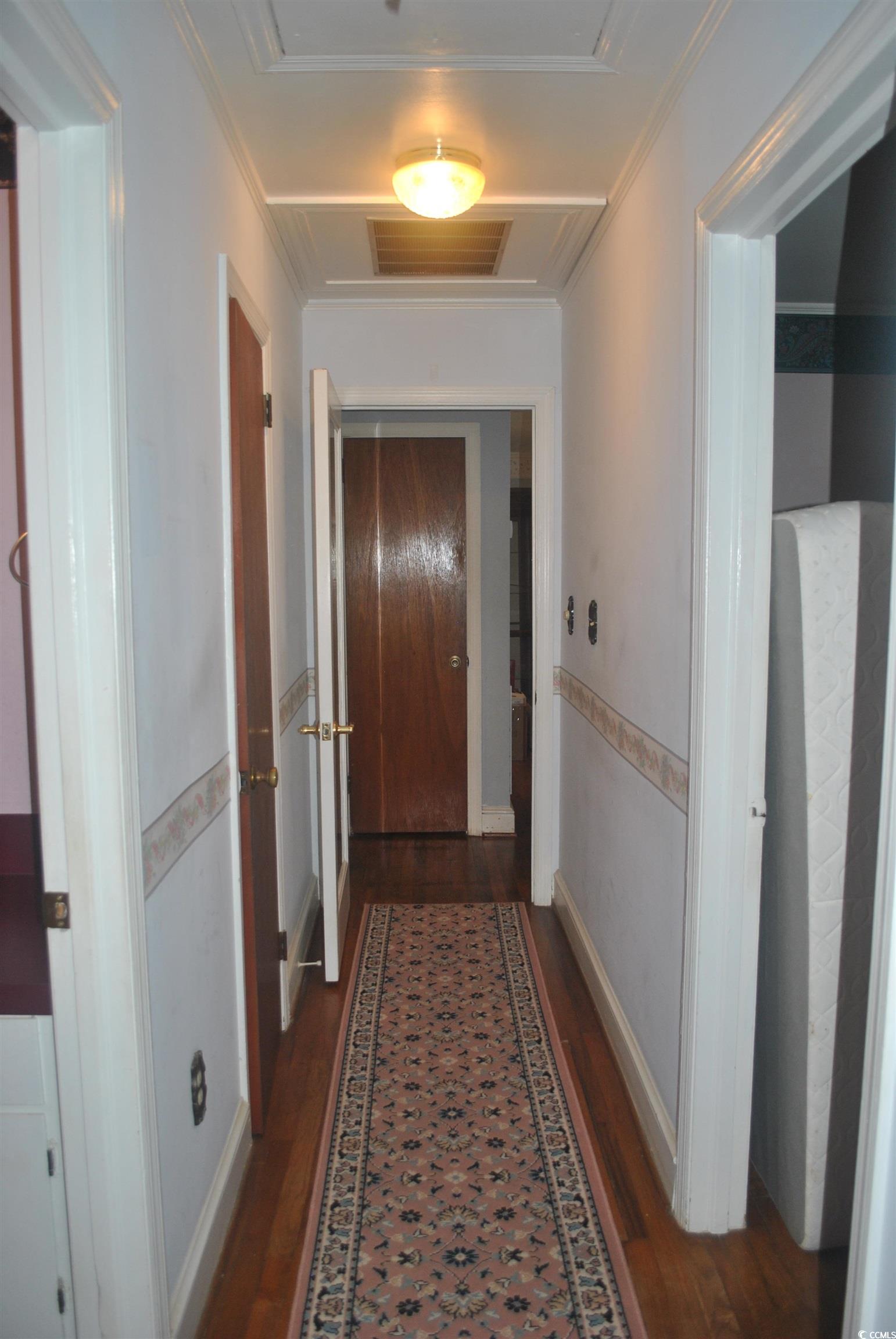 1726 Rice Street Georgetown, SC 29440 - Photo 8 of 28 Hallway with crown molding and dark hardwood / woo