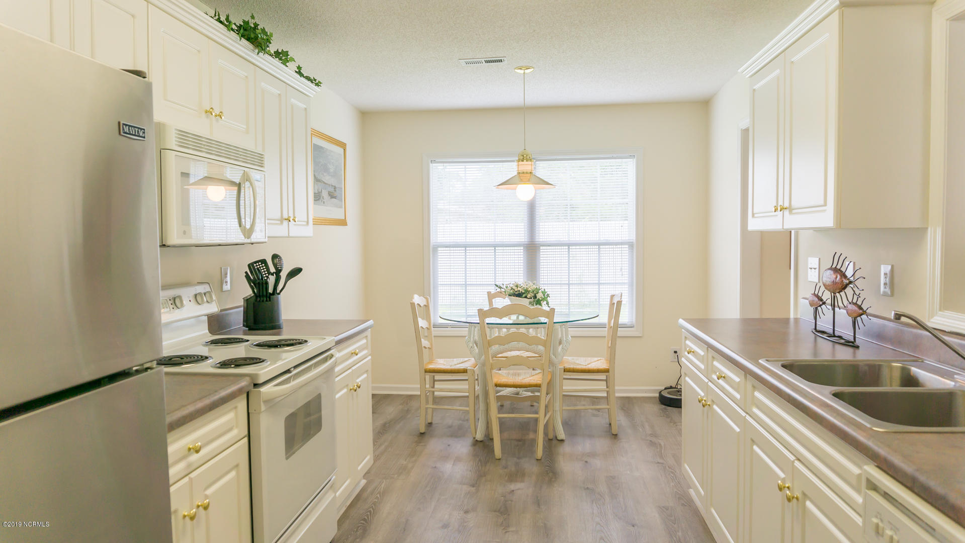 7295 Nursery Road Southwest Ocean Isle Beach, NC 28469 - Photo 17 of 31 Bright and airy, eat-in kitchen (white cabinets!)