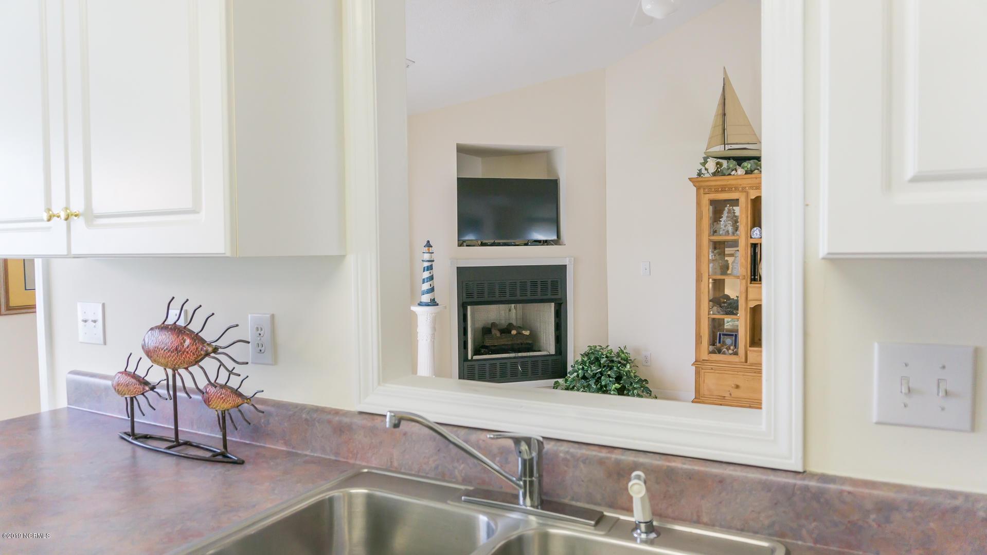 7295 Nursery Road Southwest Ocean Isle Beach, NC 28469 - Photo 19 of 31 Pass through from kitchen to living room