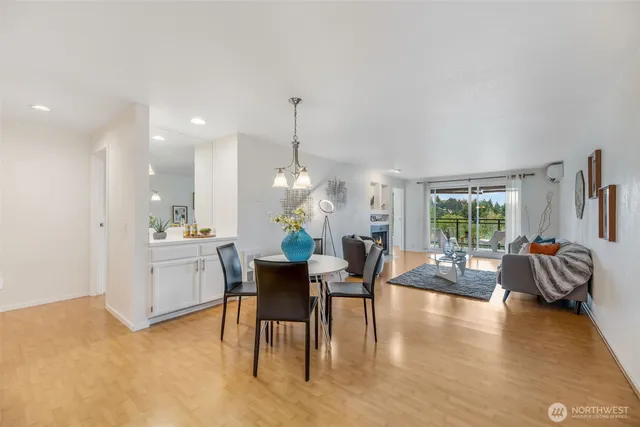 a view of a dining room with furniture a chandelier and wooden floor