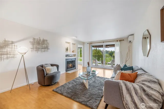 a living room with furniture a rug and a large window