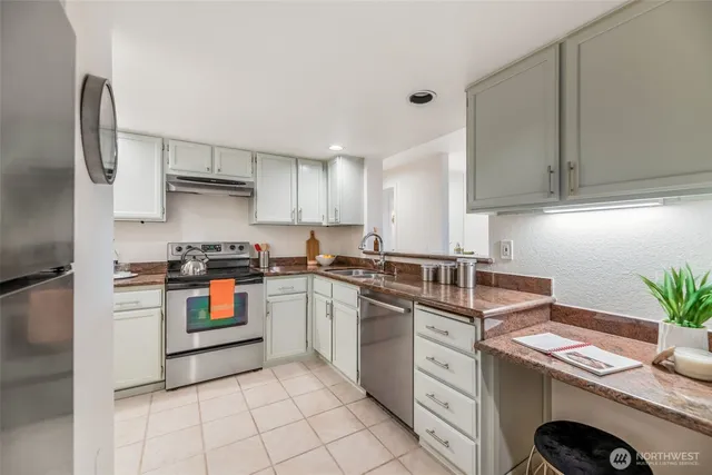 a kitchen with a sink a stove and cabinets