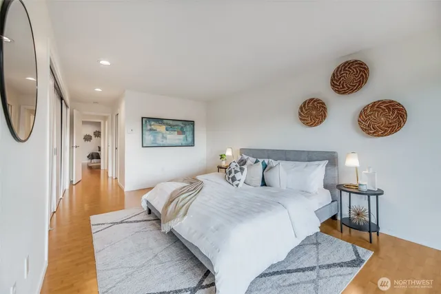 a bedroom with a bed and painting on the wall