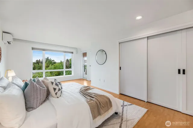 a bedroom with a large bed and a large window
