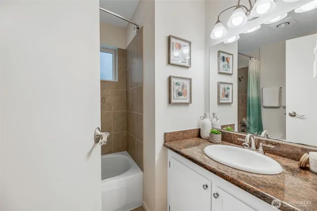 a bathroom with a granite countertop sink and a mirror