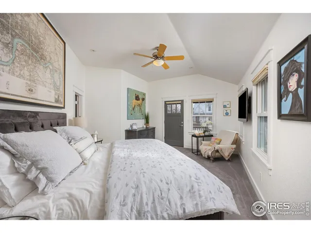 a bedroom with a bed couch and window