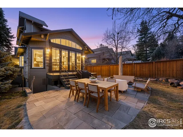 a view of a house and patio in the backyard