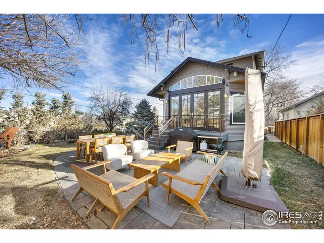 a view of a patio with a table and chairs