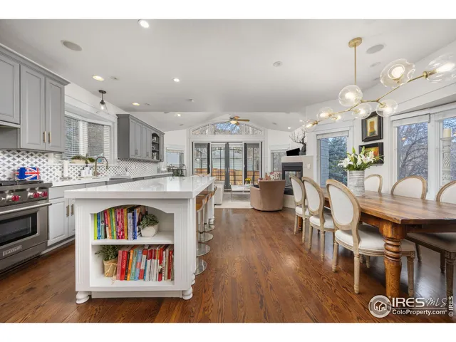 a living room with kitchen island and a wooden floor