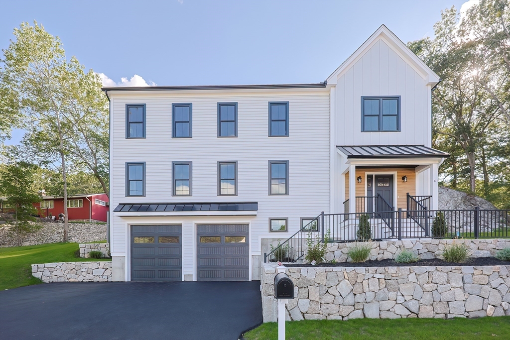 71 Old Nahant Road Wakefield, MA 01880 - Photo 2 of 42 a front view of a house with a yard and garage