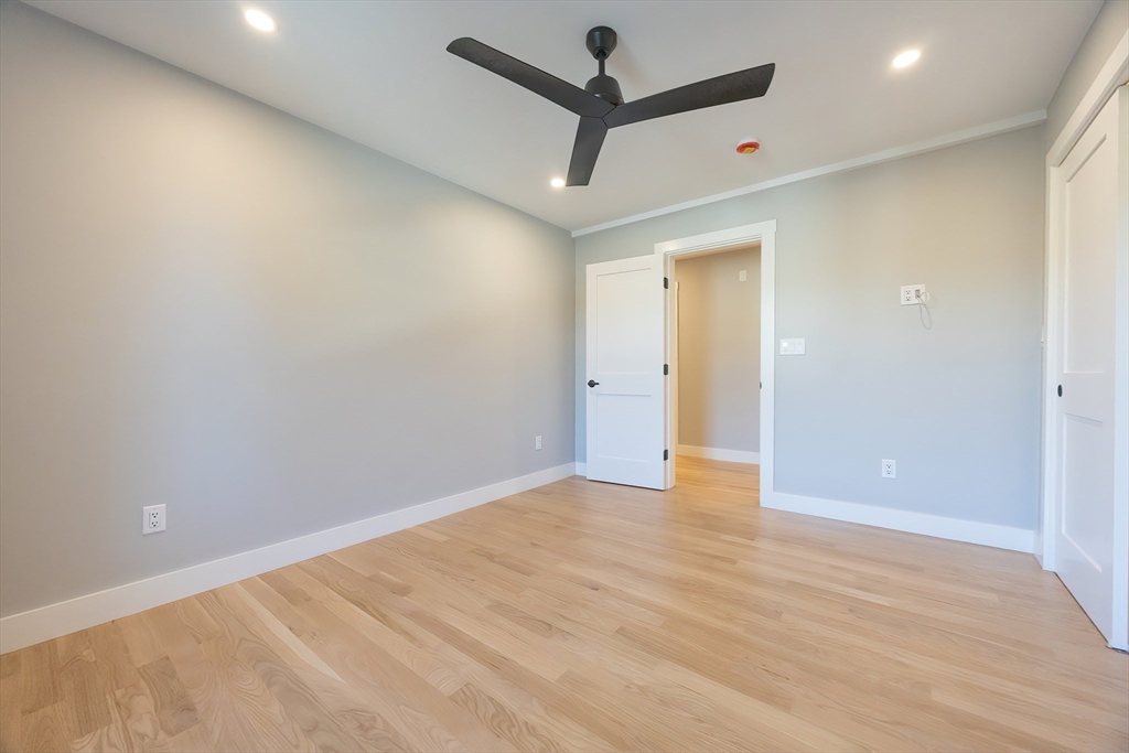 71 Old Nahant Road Wakefield, MA 01880 - Photo 22 of 42 en empty room with wooden floor and a ceiling fan