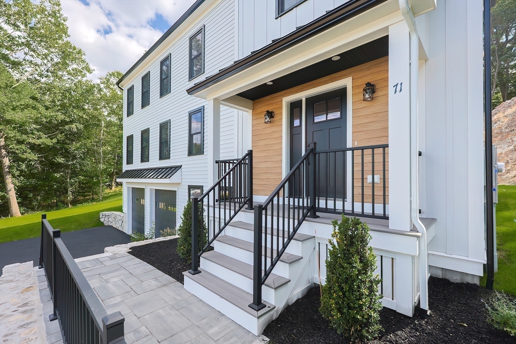 71 Old Nahant Road Wakefield, MA 01880 - Photo 6 of 42 a front view of a house with a yard table and chairs