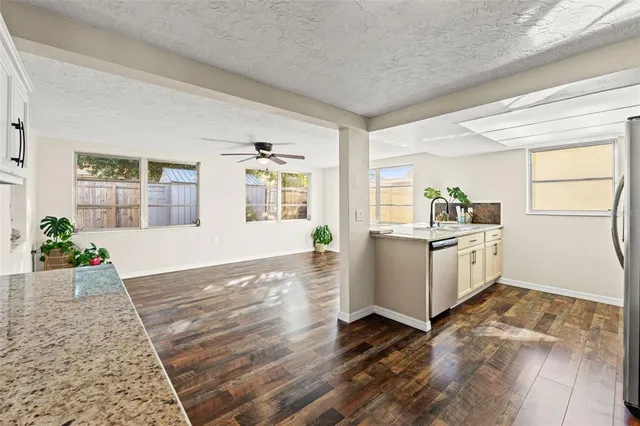 a view of a kitchen with furniture and wooden floor