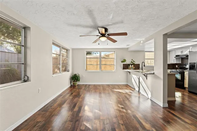 a view of a living room hardwood floor and a window