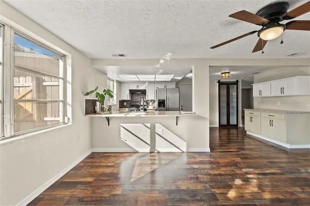 a view of kitchen with stainless steel appliances kitchen island