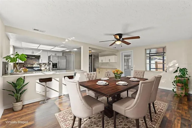 a view of a dining room with furniture and window