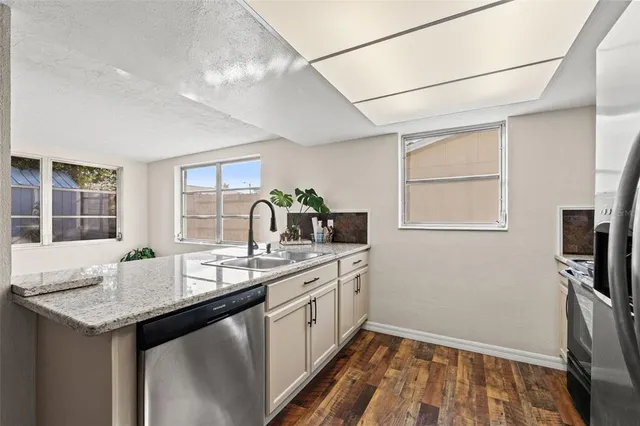 a kitchen with a sink appliances and cabinets