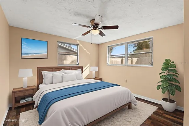 a bedroom with a bed and a potted plant