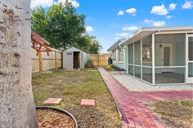 a view of an house with backyard space and balcony
