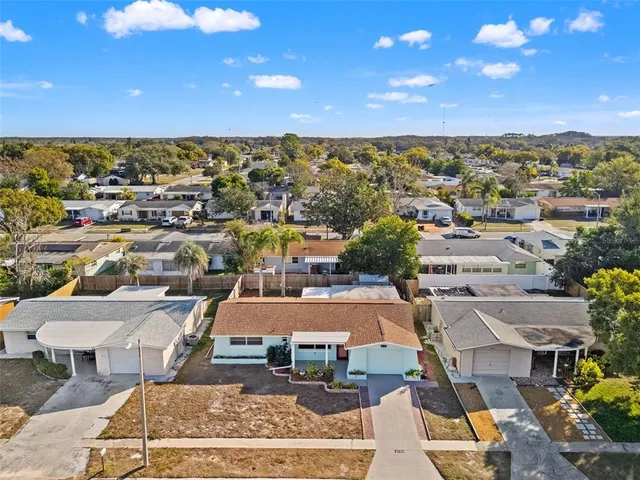 an aerial view of residential houses with outdoor space and swimming pool
