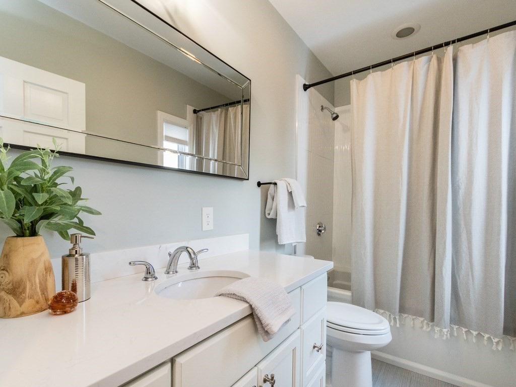 31 Gorham Street, Unit B Somerville, MA 02144 - Photo 16 of 36 a bathroom with a sink toilet and shower