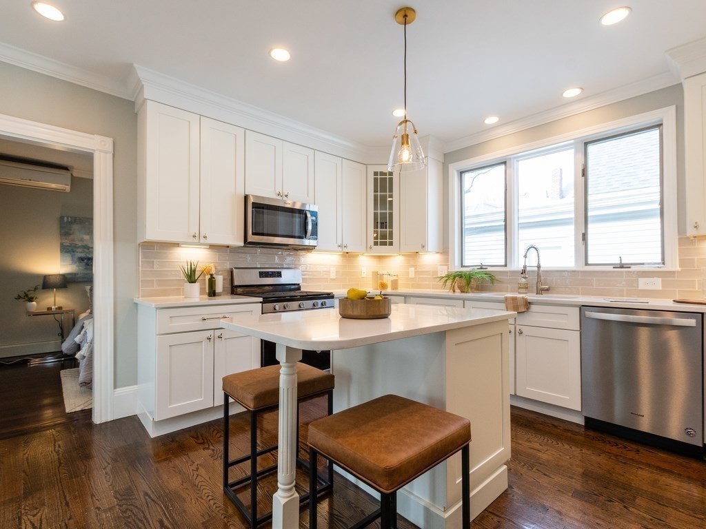 31 Gorham Street, Unit B Somerville, MA 02144 - Photo 2 of 36 a kitchen with a sink cabinets and window