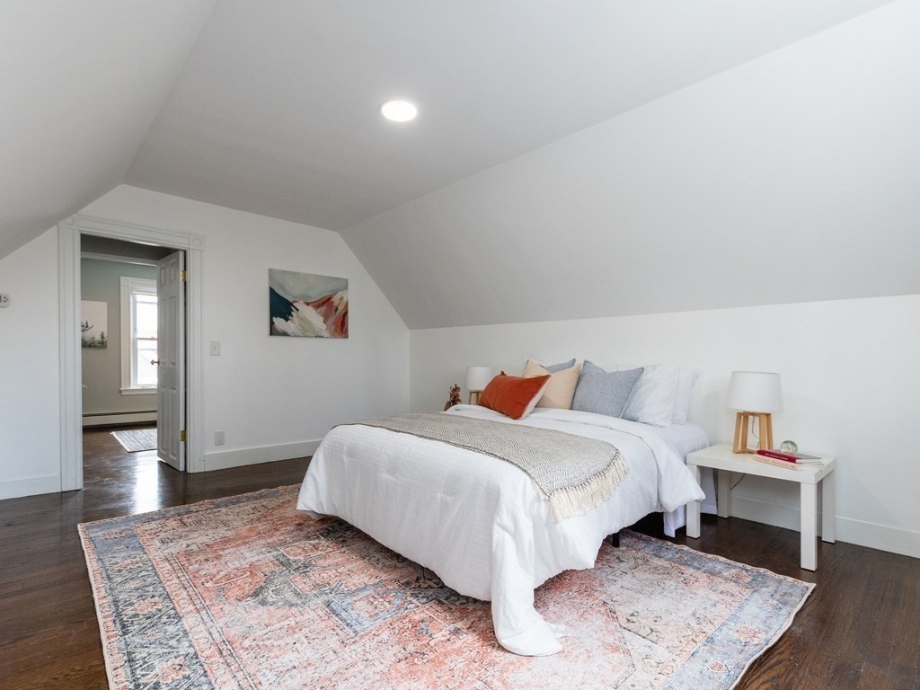 31 Gorham Street, Unit B Somerville, MA 02144 - Photo 22 of 36 a bedroom with a bed and wooden floor
