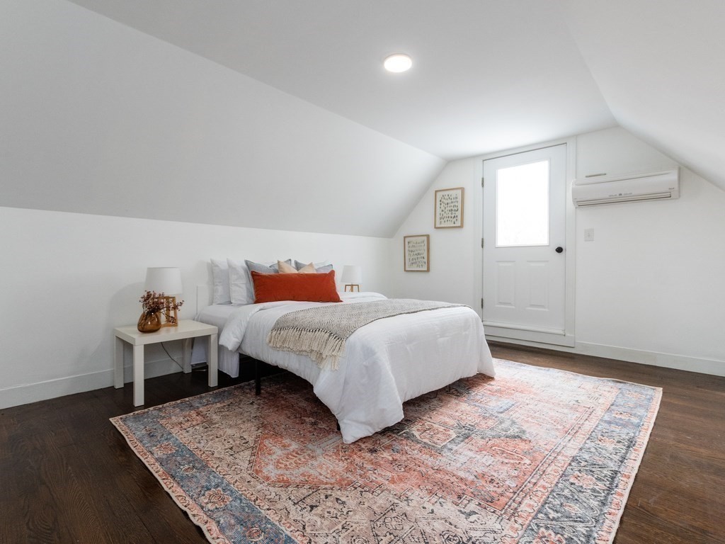 31 Gorham Street, Unit B Somerville, MA 02144 - Photo 23 of 36 a bedroom with a bed and wooden floor