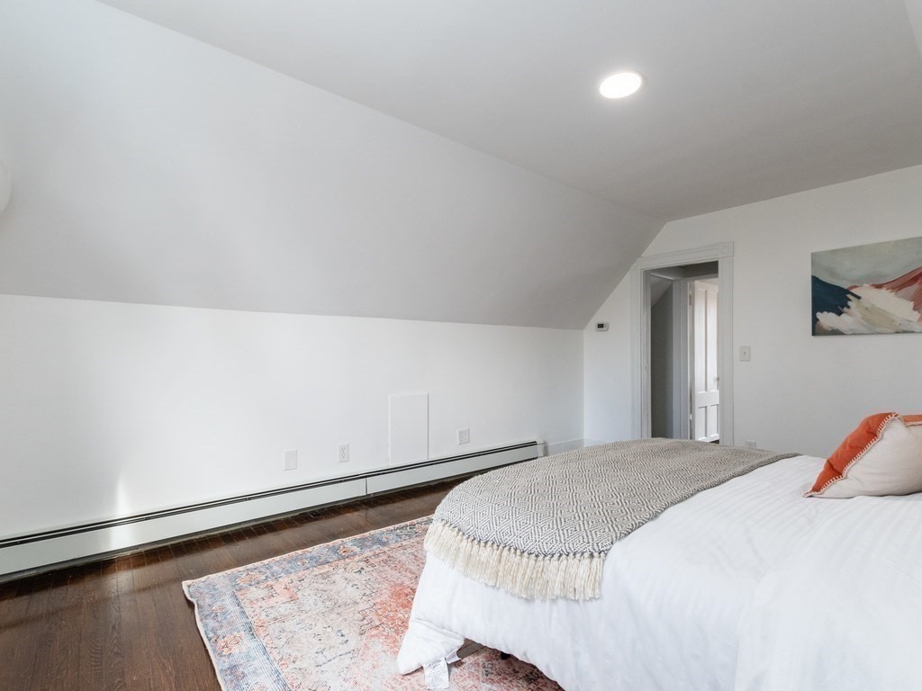 31 Gorham Street, Unit B Somerville, MA 02144 - Photo 24 of 36 a bed sitting in a bedroom and chandelier