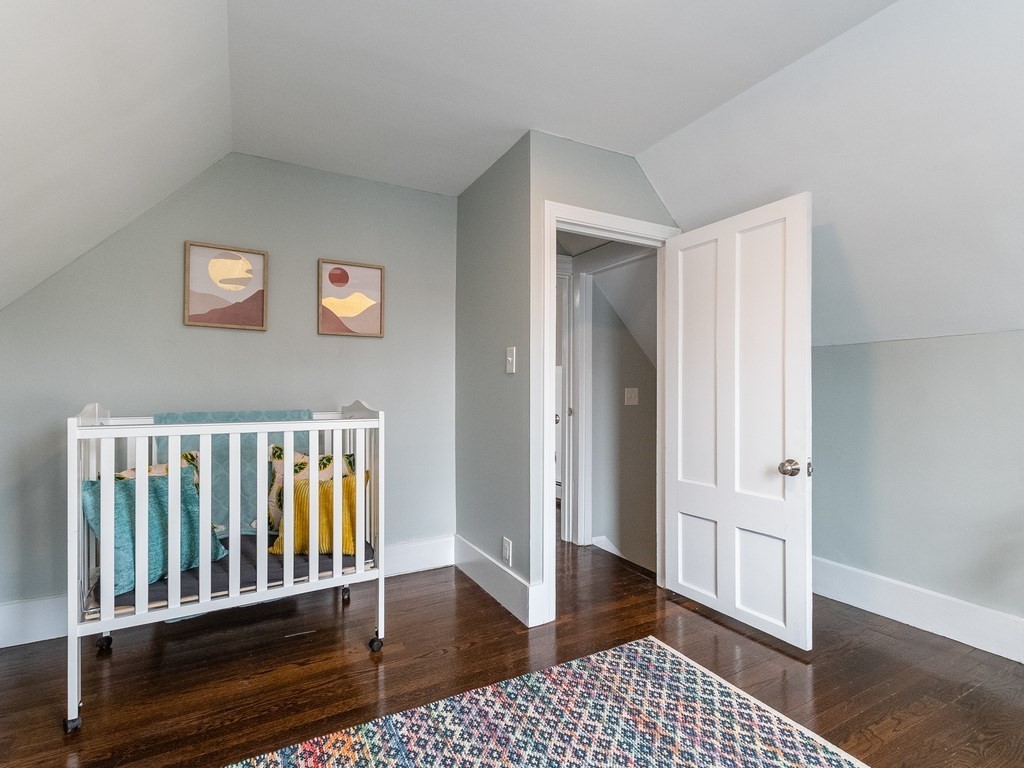 31 Gorham Street, Unit B Somerville, MA 02144 - Photo 27 of 36 wooden floor in a hall with an entryway door