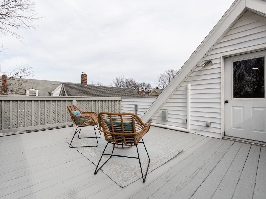 31 Gorham Street, Unit B Somerville, MA 02144 - Photo 29 of 36 a roof deck with table and chairs and wooden floor