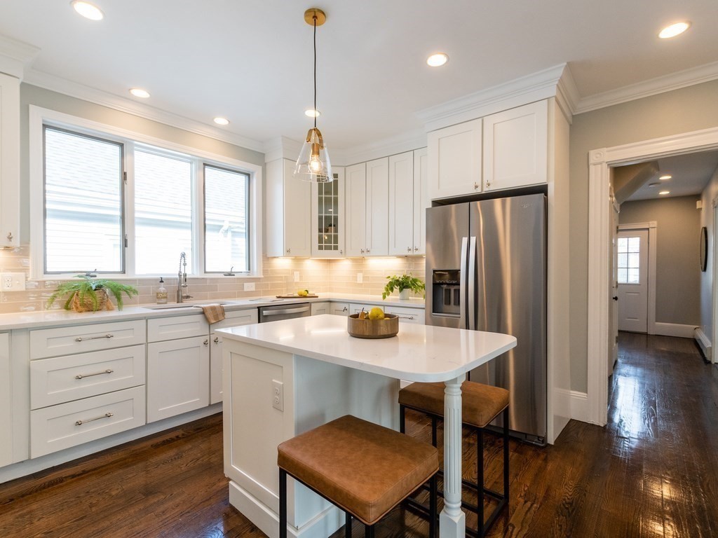 31 Gorham Street, Unit B Somerville, MA 02144 - Photo 3 of 36 a kitchen with a center island appliances and cabinets