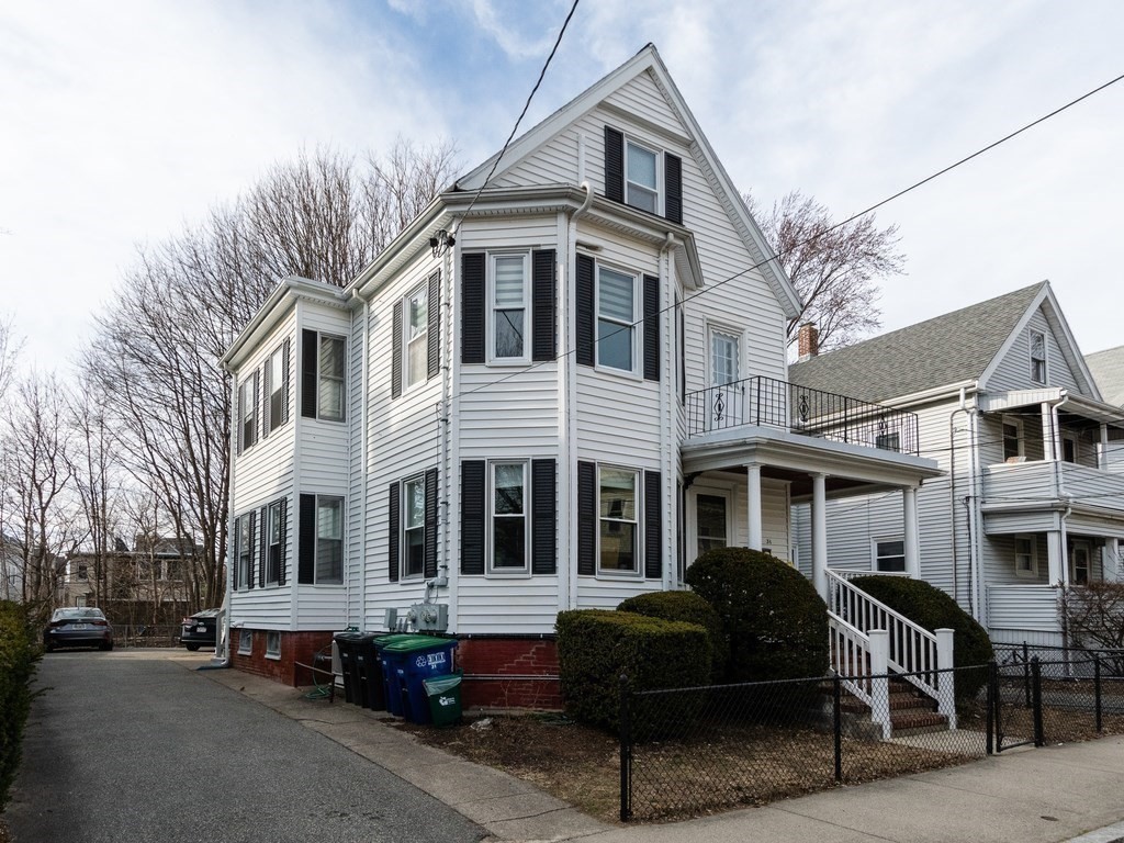 31 Gorham Street, Unit B Somerville, MA 02144 - Photo 32 of 36 a front view of a building and car parked