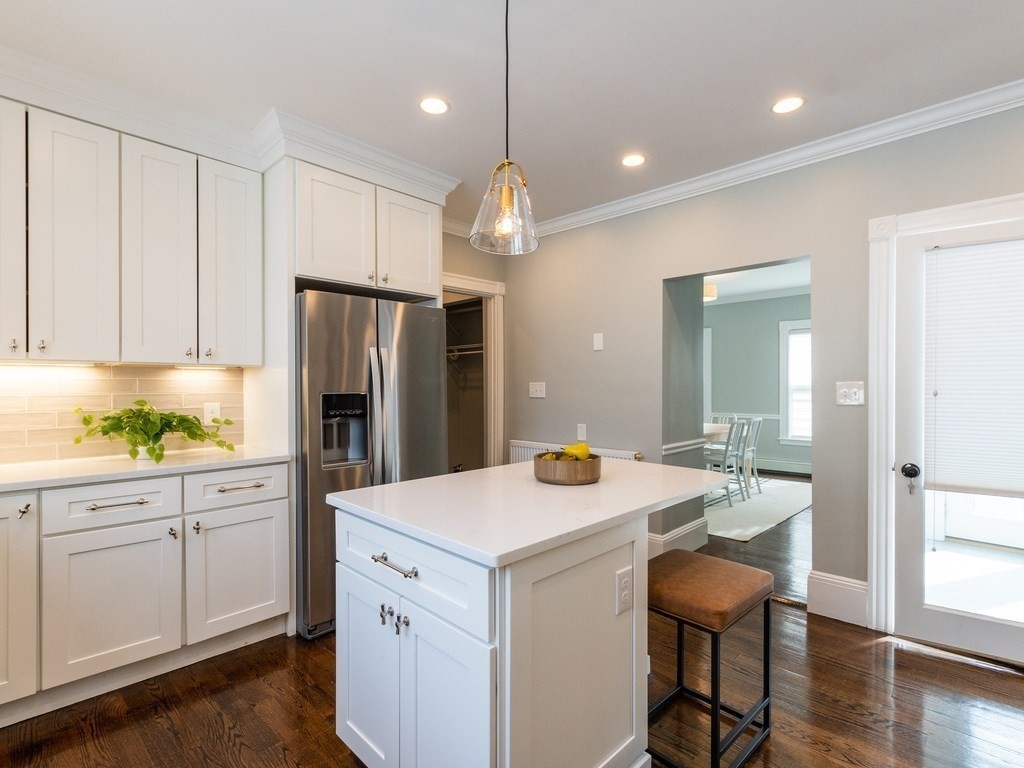 31 Gorham Street, Unit B Somerville, MA 02144 - Photo 5 of 36 a kitchen that has a lot of cabinets in it and wooden floors