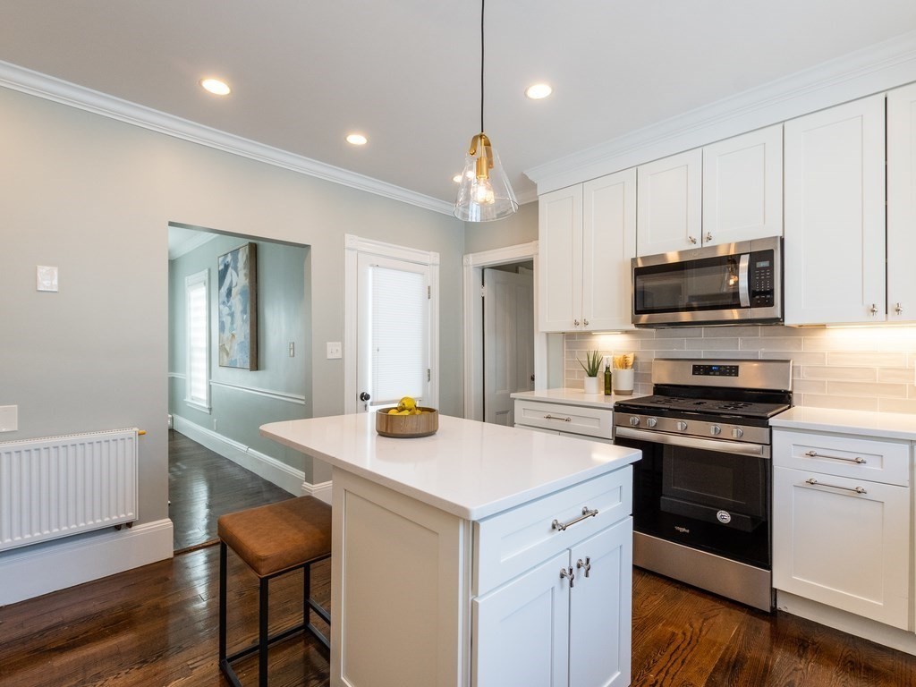 31 Gorham Street, Unit B Somerville, MA 02144 - Photo 6 of 36 a kitchen that has a sink a microwave a stove and cabinets
