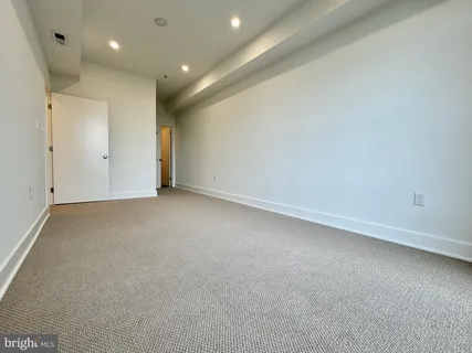 an empty room with large windows